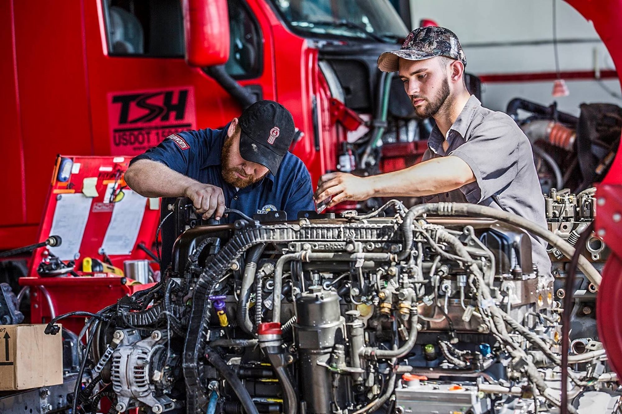 Expert mechanics working on diesel engine